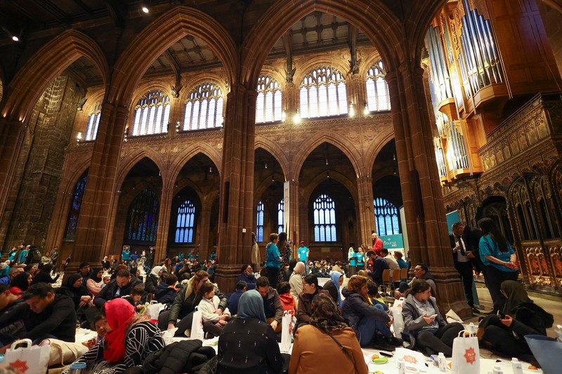People queue outside Manchester Cathedral for the Iftar (breaking fast) event during the Muslim holy fasting month of Ramadan, in Manchester, Britain, March 29, 2023. REUTERS/Molly Darlington