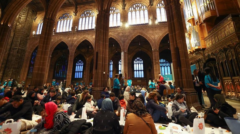People queue outside Manchester Cathedral for the Iftar (breaking fast) event during the Muslim holy fasting month of Ramadan, in Manchester, Britain, March 29, 2023. REUTERS/Molly Darlington