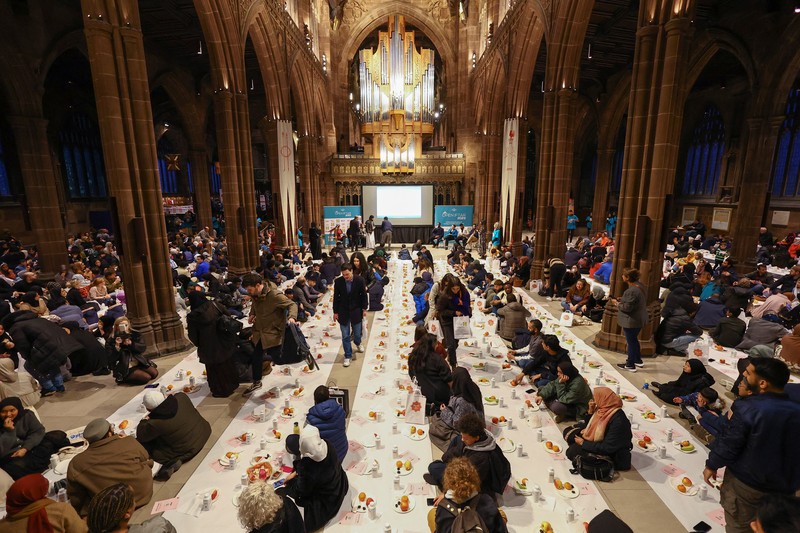 People queue outside Manchester Cathedral for the Iftar (breaking fast) event during the Muslim holy fasting month of Ramadan, in Manchester, Britain, March 29, 2023. REUTERS/Molly Darlington