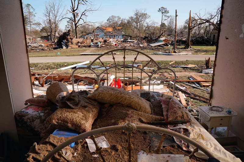 People and debris are seen through the window of a destroyed church in the aftermath of a tornado, after a monster storm system tore through the South and Midwest on Friday, in Wynne, Arkansas, U.S. April 1, 2023. REUTERS/Cheney Orr