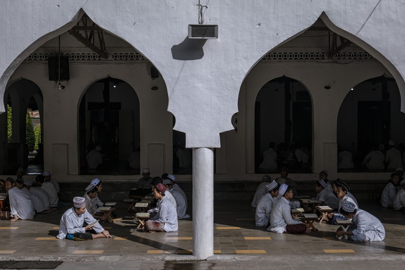 MAGETAN, INDONESIA - APRIL 02: Students learn Islamic scriptures in the Islamic boarding school Al-Fatah Temboro during the holy month of Ramadan on April 02, 2023 in Magetan, East Java, Indonesia. Al-Fatah Islamic Boarding School was founded in 1950 by KH. Kholid Umar, also known as Kyai Mahmud. Islamic boarding schools in Indonesia have around 22,000 students, including those from neighboring countries in Southeast Asia, such as Malaysia, Brunei and Thailand. The Al-Falah boarding school occupies a 50-hectare site in Temboro Village, Karas District, Magetan, East Java. It is the largest center for developing the ideology of the Tablighi Jamaat in Southeast Asia. The main goal of the Al-Fatah Islamic Boarding School is to learn about the Prophet, produce religious experts, spread Islam to all walks of life, improve oneself and uphold the da'wah journey of Allah's Apostle. The school's magnitude of the influence of religion on the lives of residents in Temboro has made this area known as the 'Village of Medina'. Students at the Pesantren, also known as 