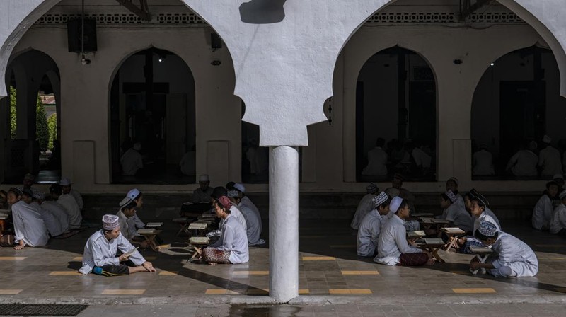 MAGETAN, INDONESIA - APRIL 02: Students learn Islamic scriptures in the Islamic boarding school Al-Fatah Temboro during the holy month of Ramadan on April 02, 2023 in Magetan, East Java, Indonesia. Al-Fatah Islamic Boarding School was founded in 1950 by KH. Kholid Umar, also known as Kyai Mahmud. Islamic boarding schools in Indonesia have around 22,000 students, including those from neighboring countries in Southeast Asia, such as Malaysia, Brunei and Thailand. The Al-Falah boarding school occupies a 50-hectare site in Temboro Village, Karas District, Magetan, East Java. It is the largest center for developing the ideology of the Tablighi Jamaat in Southeast Asia. The main goal of the Al-Fatah Islamic Boarding School is to learn about the Prophet, produce religious experts, spread Islam to all walks of life, improve oneself and uphold the da'wah journey of Allah's Apostle. The school's magnitude of the influence of religion on the lives of residents in Temboro has made this area known as the 'Village of Medina'. Students at the Pesantren, also known as 