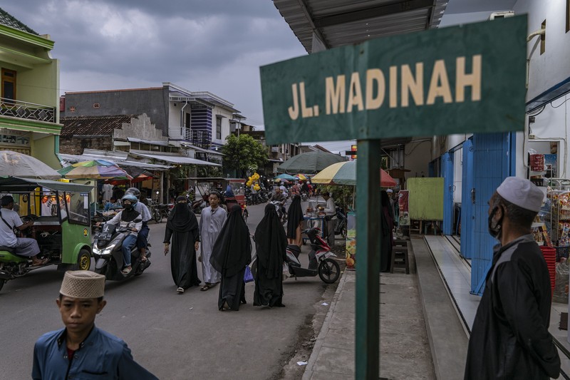 1479132692 MAGETAN, INDONESIA - APRIL 02: Students learn Islamic scriptures in the Islamic boarding school Al-Fatah Temboro during the holy month of Ramadan on April 02, 2023 in Magetan, East Java, Indonesia. Al-Fatah Islamic Boarding School was founded in 1950 by KH. Kholid Umar, also known as Kyai Mahmud. Islamic boarding schools in Indonesia have around 22,000 students, including those from neighboring countries in Southeast Asia, such as Malaysia, Brunei and Thailand. The Al-Falah boarding school occupies a 50-hectare site in Temboro Village, Karas District, Magetan, East Java. It is the largest center for developing the ideology of the Tablighi Jamaat in Southeast Asia. The main goal of the Al-Fatah Islamic Boarding School is to learn about the Prophet, produce religious experts, spread Islam to all walks of life, improve oneself and uphold the da'wah journey of Allah's Apostle. The school's magnitude of the influence of religion on the lives of residents in Temboro has made this area known as the 'Village of Medina'. Students at the Pesantren, also known as
