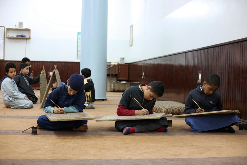 RELIGION-RAMADAN/ Boys recite Koran verses from wooden boards in a mosque during the Muslim holy fasting month of Ramadan, in Tripoli, Libya April 3, 2023. REUTERS/Hazem Ahmed