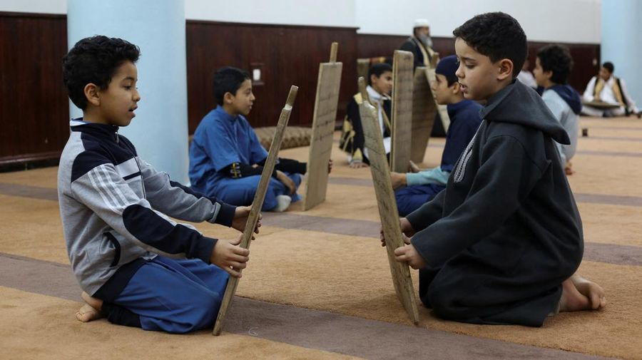 Boys recite Koran verses from wooden boards in a mosque during the Muslim holy fasting month of Ramadan, in Tripoli, Libya April 3, 2023. REUTERS/Hazem Ahmed