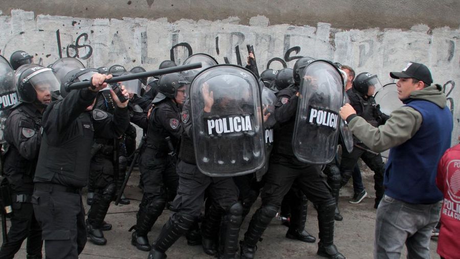 Menteri Keamanan provinsi Buenos Aires, Sergio Berni dilindungi oleh polisi dilindungi setelah dipukuli oleh sekelompok pengemudi bus yang memprotes pembunuhan seorang rekannya di La Matanza, Buenos Aires, (3/4/2023). (AFP via Getty Images/ANDRES PELOZO)