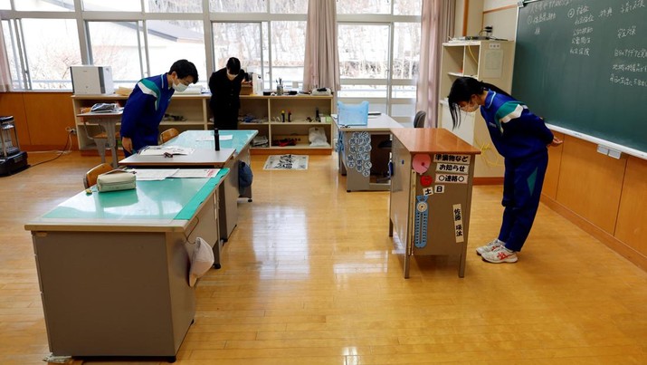 Teacher Yumemi Kanazawa, 30, Eita Sato, 15, and Aoi Hoshi, 15, the only two students at Yumoto Junior High School, attend a class a few days before their graduation and the institution's closing ceremony, in Ten-ei Village, Fukushima Prefecture, Japan, March 9, 2023. Eita and Aoi, who have been together since three, are the last two graduates of Yumoto Junior High, a public school established in 1947 that in its prosperous years sent out more than 50 graduates, but with only a few enrolments expected in the coming years, the village decided to close the school for good. 