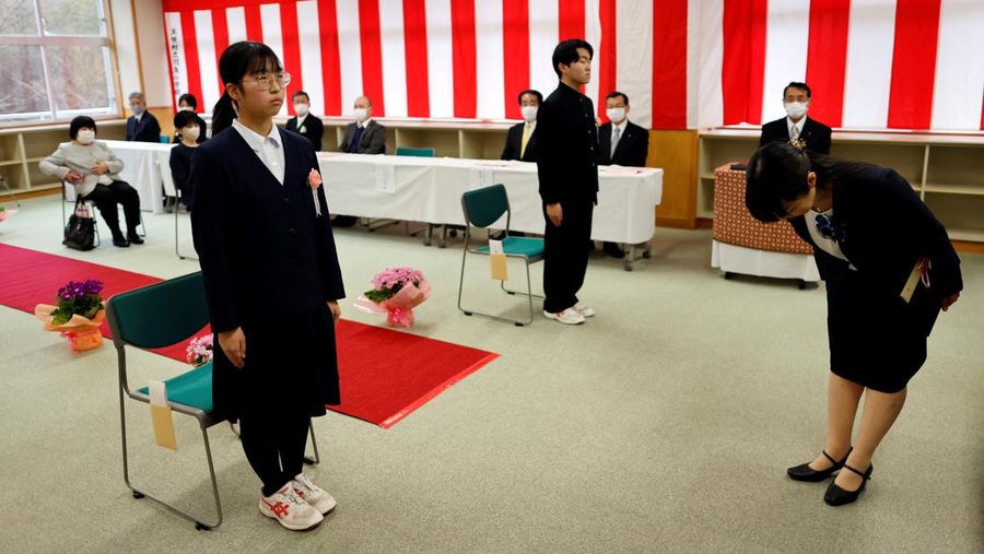 Teacher Yumemi Kanazawa, 30, Eita Sato, 15, and Aoi Hoshi, 15, the only two students at Yumoto Junior High School, attend a class a few days before their graduation and the institution's closing ceremony, in Ten-ei Village, Fukushima Prefecture, Japan, March 9, 2023. Eita and Aoi, who have been together since three, are the last two graduates of Yumoto Junior High, a public school established in 1947 that in its prosperous years sent out more than 50 graduates, but with only a few enrolments expected in the coming years, the village decided to close the school for good. 