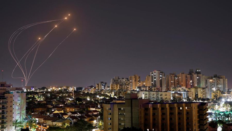 Streaks of light are seen as Israel's Iron Dome anti-missile system intercept rockets launched from the Gaza Strip, as seen from Ashkelon, April 7, 2023. REUTERS/ Amir Cohen