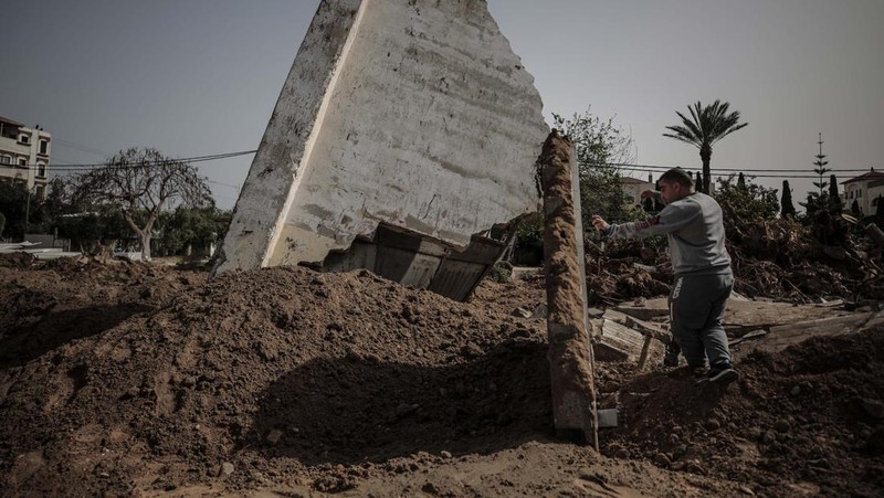 Warga Palestina memeriksa rumah mereka yang hancur setelah Israel melancarkan serangan udara di kantong Palestina. Israel melancarkan serangan udara sebelum fajar pada 7 April 2023 di Jalur Gaza dan Lebanon, mengatakan pihaknya menargetkan Hamas sebagai pembalasan atas beberapa lusin roket yang ditembakkan ke Israel dari kedua wilayah tersebut. Militer Israel telah menyerang sasaran di Jalur Gaza, mendorong wilayah itu ke arah kebakaran yang lebih luas setelah seharian tembakan roket di sepanjang perbatasan utara dan selatan negara itu. Pertempuran itu terjadi setelah kerusuhan selama dua hari di tempat suci paling sensitif di Yerusalem. Ketika pesawat Israel mulai menyerang Gaza, militan Palestina dengan cepat menembakkan rentetan roket baru, memicu sirene serangan udara melintasi Israel selatan.(Ahmed Zakot/SOPA Images/LightRocket via Getty Images)