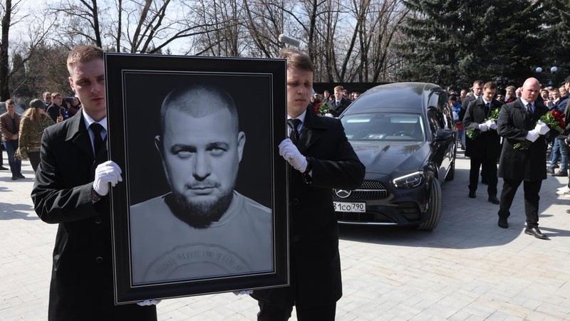 Para karyawan mengubur peti mati berisi jenazah blogger militer Vladlen Tatarsky (nama asli Maxim Fomin) selama pemakaman di Moskow pada 8 April 2023. - Ratusan pendukung hadir pada 8 April 2023, untuk pemakaman seorang petinggi Rusia blogger militer tewas dalam serangan bom. (ALEXANDER NEMENOV/AFP via Getty Images)