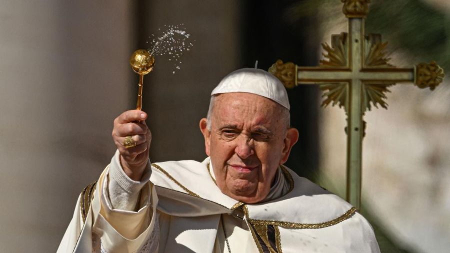 Paus Fransiskus memerciki hadirin dengan air selama misa Minggu Paskah pada 9 April 2023 di lapangan Santo Petrus di Vatikan, sebagai bagian dari perayaan Pekan Suci. (ANDREAS SOLARO/AFP via Getty Images)