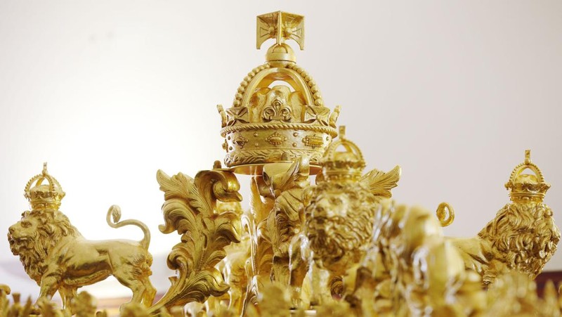The Diamond Jubilee State Coach on display at the Royal Mews in Buckingham Palace, London, Tuesday April 4, 2023, in which King Charles III and the Queen Consort will travel to the coronation. King Charles III is taking a short cut and smoother ride to Westminster Abbey, trimming the procession route his mother took in 1953 as he aims for a more modest coronation that will include some modern touches, Buckingham Palace said Sunday April 9, 2023. (Yui Mok/PA via AP)