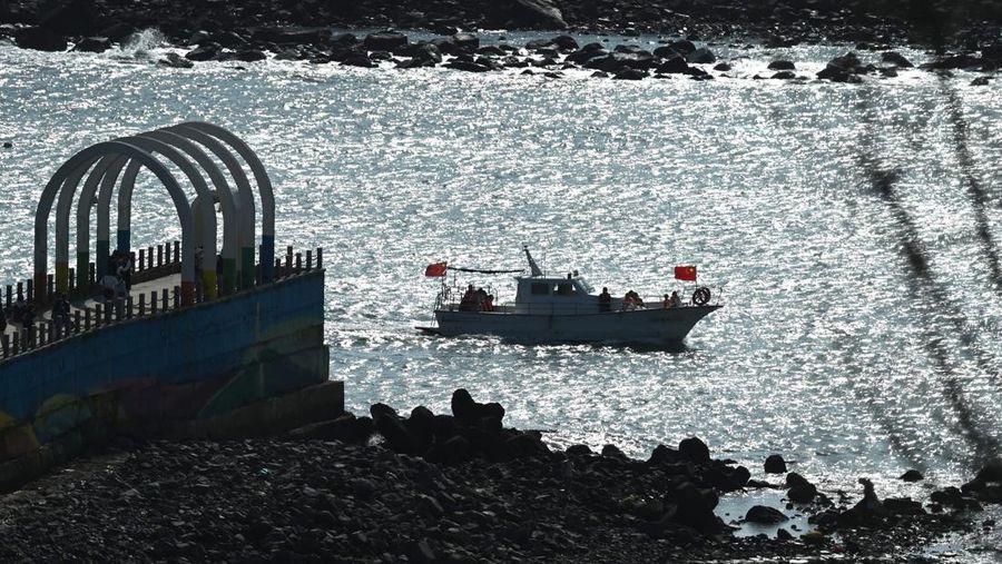 Sebuah kapal wisata berlayar di sepanjang pantai pulau Pingtan, di seberang Taiwan, di provinsi Fujian tenggara China pada 9 April 2023. - China melakukan latihan militer hari kedua di sekitar Taiwan pada 9 April, dalam apa yang disebutnya 