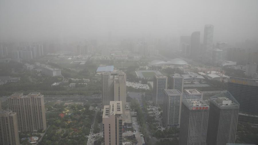 Distrik pesisir timur terlihat dalam debu yang mengambang di Kota Lianyungang, provinsi Jiangsu, China Timur pada 11 April 2023. (CFOTO/Future Publishing via Getty Images)