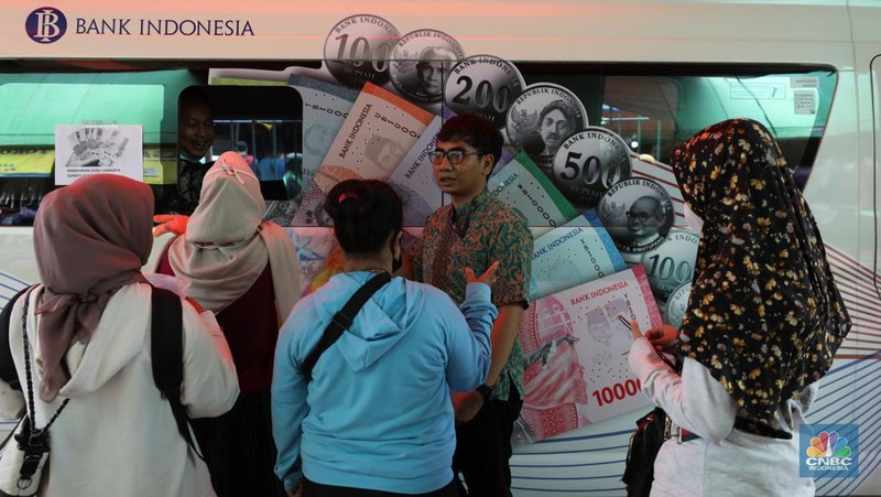 Warga menukarkan pecahan uang baru di mobil kas keliling Bank Indonesia (BI) di Pasar Palmerah, Jakarta, Selasa (11/4/2023). (CNBC Indonesia/Tri Susilo)