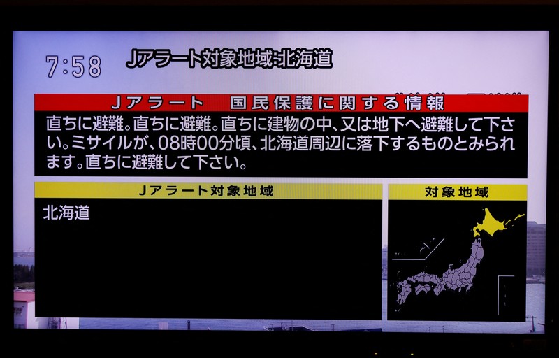 A TV screen displays a warning message called 
