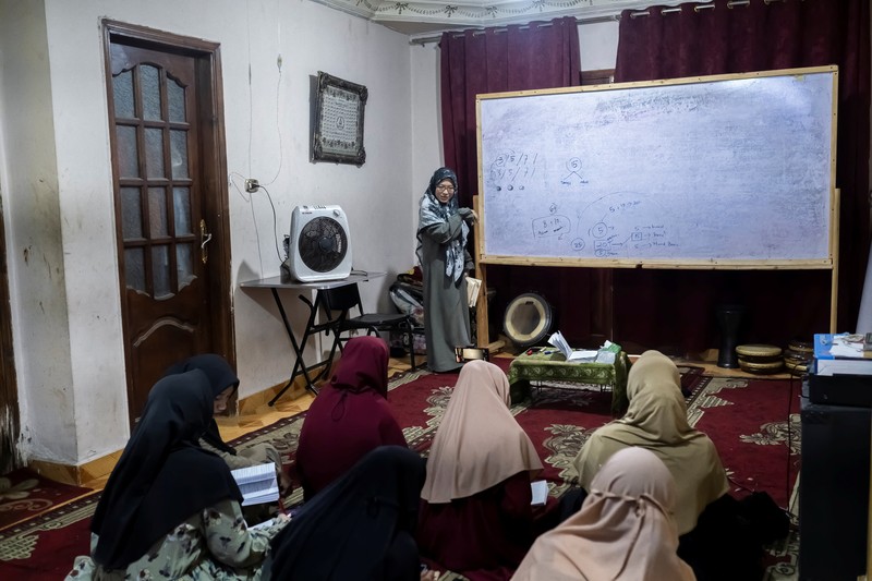 Indonesian student Nuni Nuraini Ahyani, 25, leaves the house to give a lesson on Hadith for new students during the holy month of Ramadan, after her day studying Usul al-Din with a specialization in Hadith at Al-Azhar University in old Islamic Cairo, Egypt April 4, 2023. REUTERS/Fatma Fahmy