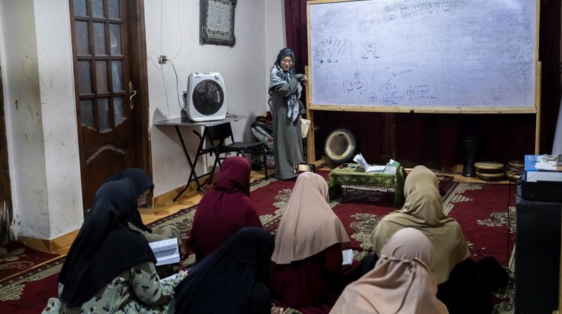Indonesian student Nuni Nuraini Ahyani, 25, leaves the house to give a lesson on Hadith for new students during the holy month of Ramadan, after her day studying Usul al-Din with a specialization in Hadith at Al-Azhar University in old Islamic Cairo, Egypt April 4, 2023. REUTERS/Fatma Fahmy