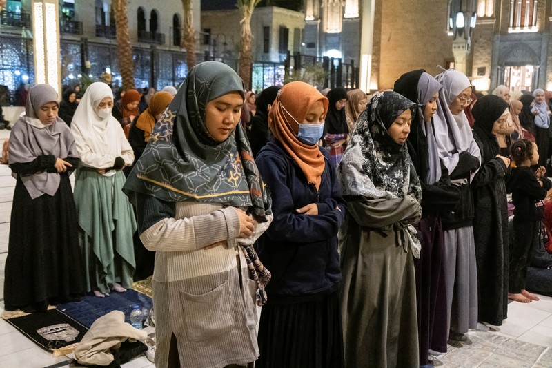 Indonesian student Nuni Nuraini Ahyani, 25, leaves the house to give a lesson on Hadith for new students during the holy month of Ramadan, after her day studying Usul al-Din with a specialization in Hadith at Al-Azhar University in old Islamic Cairo, Egypt April 4, 2023. REUTERS/Fatma Fahmy