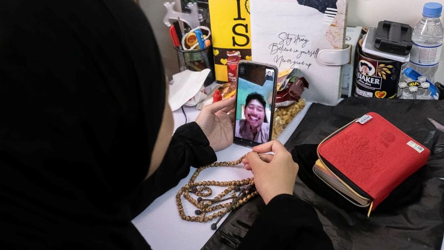 Indonesian student Nuni Nuraini Ahyani, 25, leaves the house to give a lesson on Hadith for new students during the holy month of Ramadan, after her day studying Usul al-Din with a specialization in Hadith at Al-Azhar University in old Islamic Cairo, Egypt April 4, 2023. REUTERS/Fatma Fahmy