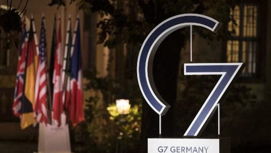 A Logo of the G7 with national flags in the background are pictured during a G7 Interior Ministers Meeting in the wine estate Schloss Vollrads in Oestrich-Winkel, western Germany, on November 17, 2022. (Photo by Hannes P Albert / POOL / AFP)