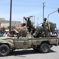 Warga Sudan menyapa tentara, yang setia kepada panglima militer Abdel Fattah al-Burhan, di kota Laut Merah Port Sudan pada 16 April 2023. - Pejuang yang berjuang di Sudan mengatakan mereka telah menyetujui jeda kemanusiaan selama berjam-jam, termasuk