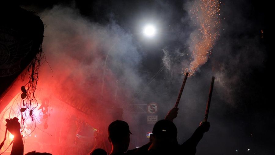 YOGYAKARTA, INDONESIA - APRIL 21: Indonesian Muslims play with fire during a parade as Muslims celebrate Eid Al-Fitr to mark the end of the holy month of Ramadan on April 21, 2023 in Yogyakarta, Indonesia. Muslims around the world celebrate Eid al-Fitr with their families with feasts to mark the end of Ramadan, the holy month of fasting. (Photo by Ulet Ifansasti/Getty Images)