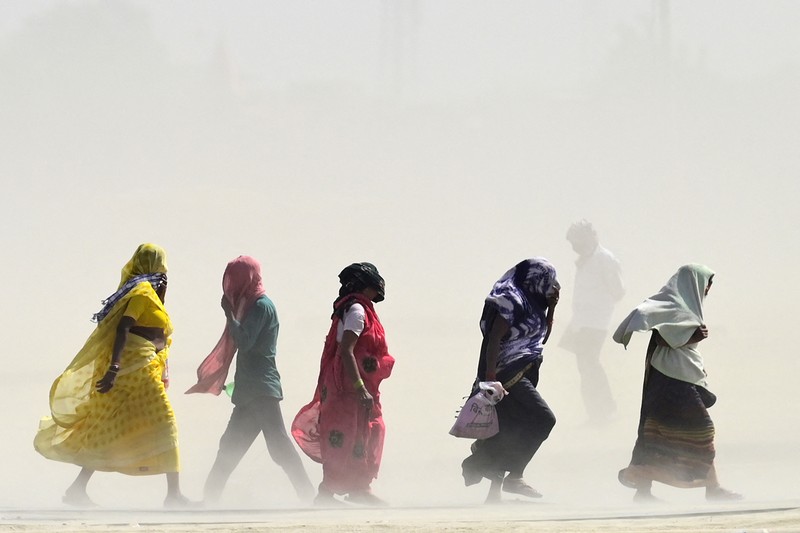 People walk through a dust storm on a hot summer day in Prayagraj on April 18, 2023. (Photo by Sanjay KANOJIA / AFP) (Photo by SANJAY KANOJIA/AFP via Getty Images)