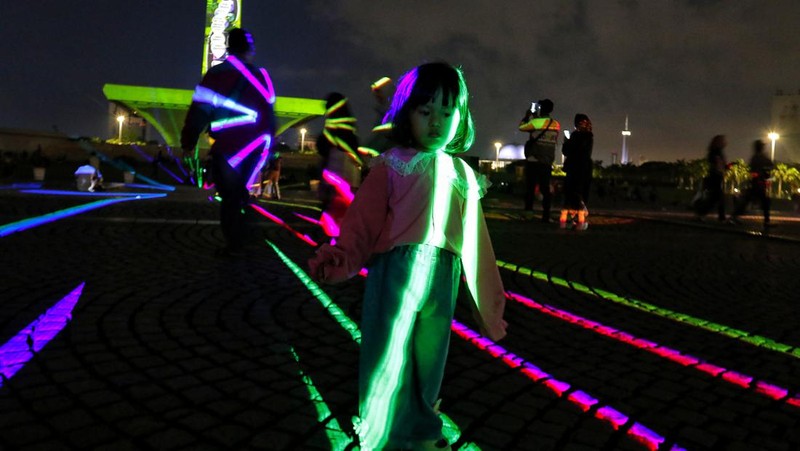 Pengunjung menyaksikan tayangan video mapping di kawasan Monas Jakarta Indonesia pada 23 April 2023. Bertepatan dengan libur Idul Fitri, Pemprov DKI Jakarta menggelar Pekan Kegiatan Monas 2023 yang ditandai dengan tayangan video mapping. (Eko Siswono Toyudho/Anadolu Agency via Getty Images)