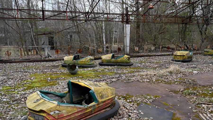 Swings and a ferris wheel remain in an abandoned amusement park of Pripyat, Ukraine. The park was scheduled to open on May 1, 1986, for the Soviet May Day celebrations. It never opened, as the Chernobyl disaster happened on April 26, 1986, a week before the opening. (Claudia Himmelreich/McClatchy DC/Tribune News Service via Getty Images)