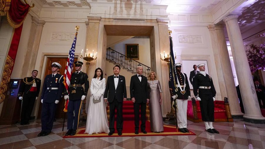 South Korea's President Yoon Suk Yeol and his wife Kim Keon Hee and President Joe Biden and first lady Jill Biden arrive for a photo in front of the Grand Staircase during a State Dinner at the White House in Washington, Wednesday, April 26, 2023. (AP Photo/Susan Walsh)