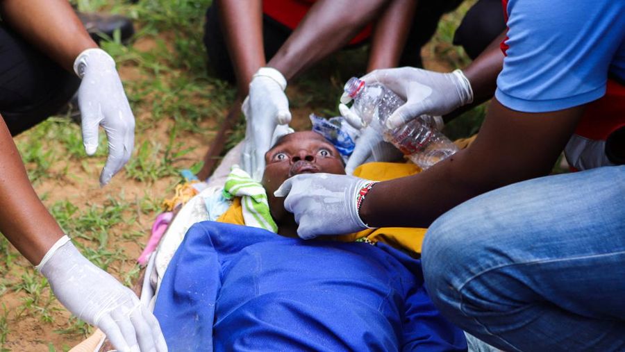 Members of the Kenya Red Cross attend to an emaciated member of a Christian cult named as Good News International Church, whose members believed they would go to heaven if they starved themselves to death, in Shakahola forest of Kilifi county, Kenya April 23, 2023. REUTERS/Stringer