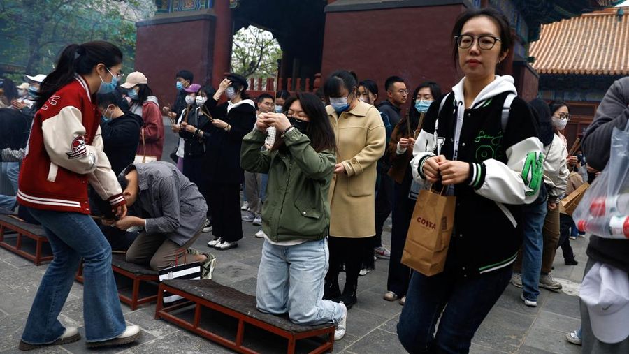 People burn incense sticks to pray for good fortune at Lama Temple, in Beijing, China April 22, 2023. REUTERS/Tingshu Wang