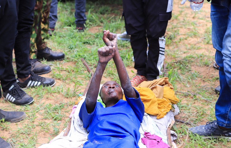 KENYA-RELIGION/ Steven Mwiti holds a photograph of his late wife Joan Bahati, a follower of a Christian cult named