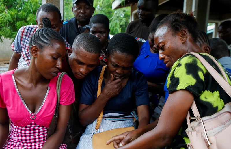 KENYA-RELIGION/ Steven Mwiti holds a photograph of his late wife Joan Bahati, a follower of a Christian cult named