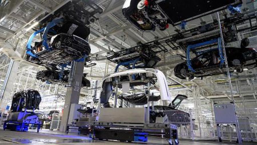 Mercedes-Benz EQS and S-Class passenger cars are transported automatically to their next production step while on the ground automatic vehicles transport body components at the 'Factory 56', a completely digitized assembly line, at the Mercedes-Benz manufacturing plant in Sindelfingen, southwestern Germany, on February 13, 2023. - Mercedes-Benz will present their 2022 annual results on February 17, 2023. (Photo by THOMAS KIENZLE / AFP)