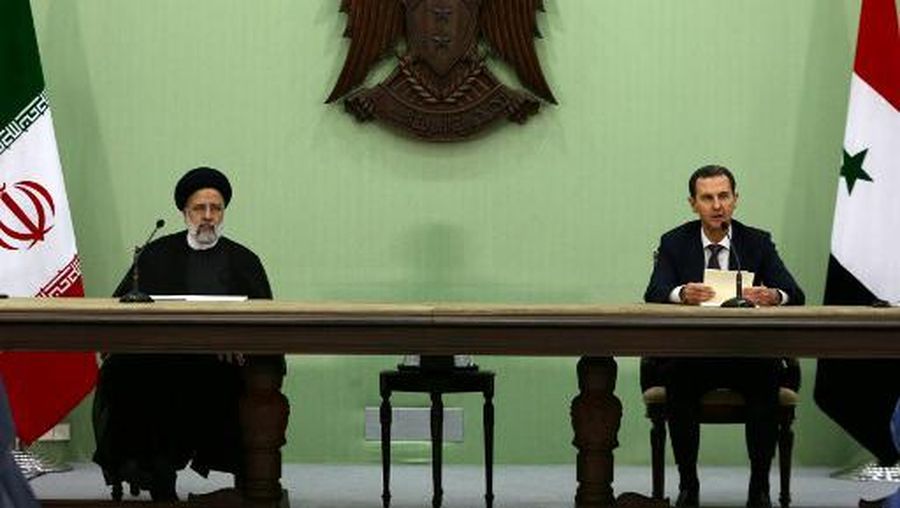 Syria's President Bashar al-Assad (R) and his Iranian counterpart Ebrahim Raisi give a joint press conference in Damascus on May 3, 2023. - The visiting Iranian president hailed al-Assad for overcoming sanctions and achieving 