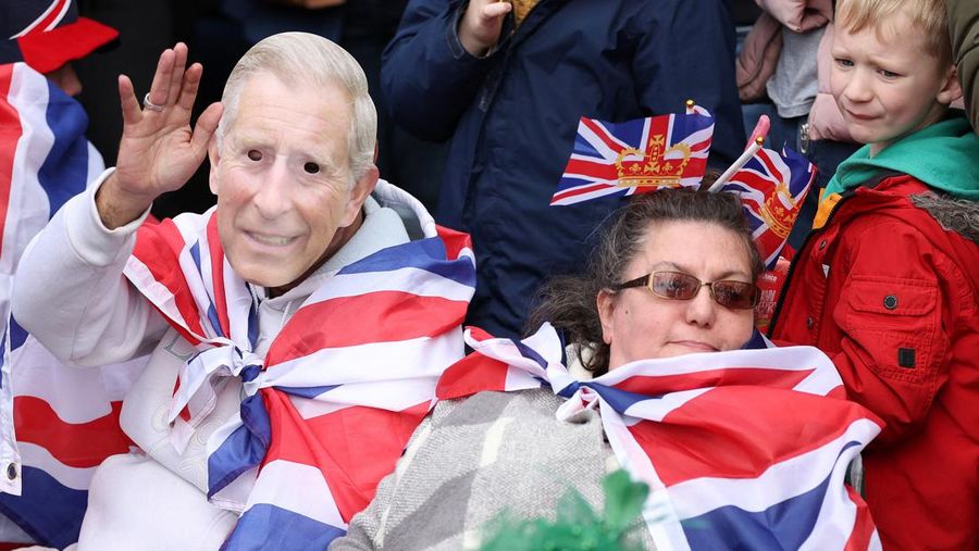 Warga saat menghadiri penobatan Raja Charles III dan Ratu Camilia dari luar Westminster Abbey, London, Inggri, Sabtu (6/5/20023). (REUTERS