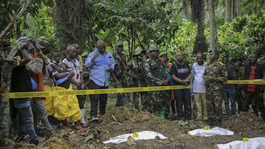 Petugas forensik memeriksa jenazah manusia pada lokasi penemujan kuburan massal di desa Ndoma, dekat Beni di Kivu Utara, Kongo, Sabtu (6/5/2023). (AP Photo)