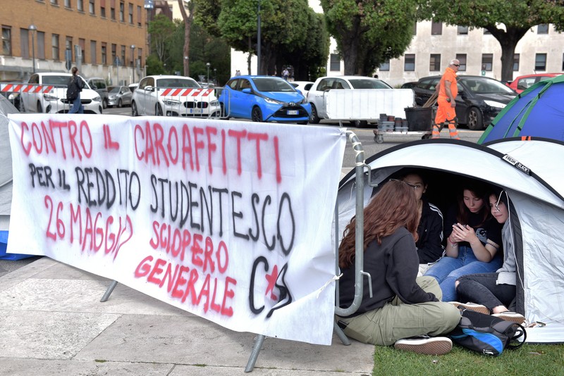 Mahasiswa Universitas La Sapienza melakukan aksi protes terkait tingginya biaya sewa hunian dengan mendirikan tenda dan berkemah di depan patung Minerva, Roma, Italia, Kamis (11/5/2023). Mahasiswa Universitas La Sapienza melakukan aksi protes terkait tingginya biaya sewa hunian dengan mendirikan tenda dan berkemah di depan patung Minerva, Roma, Italia, Kamis (11/5/2023). (Simona Granati - Corbis/Corbis via Getty Images)