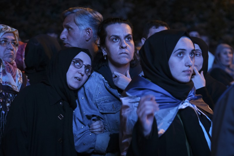 Pendukung Presiden Recep Tayyip Erdogan dan Partai AK (AK Party) menyaksikan hasil pemilu di layar lebar di depan markas AKP pada 14 Mei 2023 di Istanbul Turki. (Mehmet Kacmaz/Getty Images)