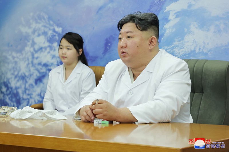 NORTHKOREA-MILITARY/ North Korean leader Kim Jong Un and his daughter Kim Ju Ae meet with members of the Non-permanent Satellite Launch Preparatory Committee, as he inspects the country's first military reconnaissance satellite, in Pyongyang, North Korea May 16, 2023, in this image released by North Korea's Korean Central News Agency on May 17, 2023. KCNA via REUTERS ATTENTION EDITORS - THIS IMAGE WAS PROVIDED BY A THIRD PARTY. REUTERS IS UNABLE TO INDEPENDENTLY VERIFY THIS IMAGE. NO THIRD PARTY SALES. SOUTH KOREA OUT. NO COMMERCIAL OR EDITORIAL SALES IN SOUTH KOREA. IMAGE HAS BEEN DIGITALLY OBSCURED AT SOURCE