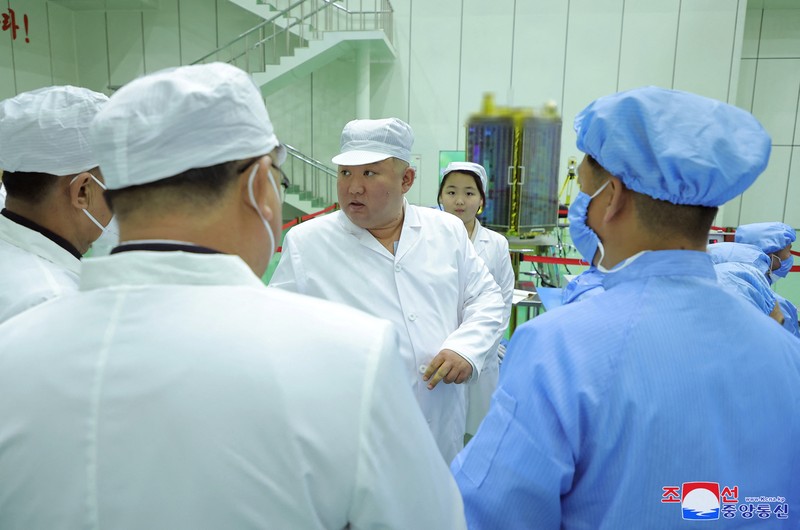 NORTHKOREA-MILITARY/ North Korean leader Kim Jong Un and his daughter Kim Ju Ae meet with members of the Non-permanent Satellite Launch Preparatory Committee, as he inspects the country's first military reconnaissance satellite, in Pyongyang, North Korea May 16, 2023, in this image released by North Korea's Korean Central News Agency on May 17, 2023. KCNA via REUTERS ATTENTION EDITORS - THIS IMAGE WAS PROVIDED BY A THIRD PARTY. REUTERS IS UNABLE TO INDEPENDENTLY VERIFY THIS IMAGE. NO THIRD PARTY SALES. SOUTH KOREA OUT. NO COMMERCIAL OR EDITORIAL SALES IN SOUTH KOREA. IMAGE HAS BEEN DIGITALLY OBSCURED AT SOURCE