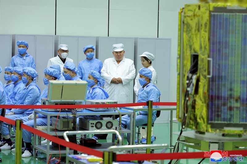 NORTHKOREA-MILITARY/ North Korean leader Kim Jong Un and his daughter Kim Ju Ae meet with members of the Non-permanent Satellite Launch Preparatory Committee, as he inspects the country's first military reconnaissance satellite, in Pyongyang, North Korea May 16, 2023, in this image released by North Korea's Korean Central News Agency on May 17, 2023. KCNA via REUTERS ATTENTION EDITORS - THIS IMAGE WAS PROVIDED BY A THIRD PARTY. REUTERS IS UNABLE TO INDEPENDENTLY VERIFY THIS IMAGE. NO THIRD PARTY SALES. SOUTH KOREA OUT. NO COMMERCIAL OR EDITORIAL SALES IN SOUTH KOREA. IMAGE HAS BEEN DIGITALLY OBSCURED AT SOURCE
