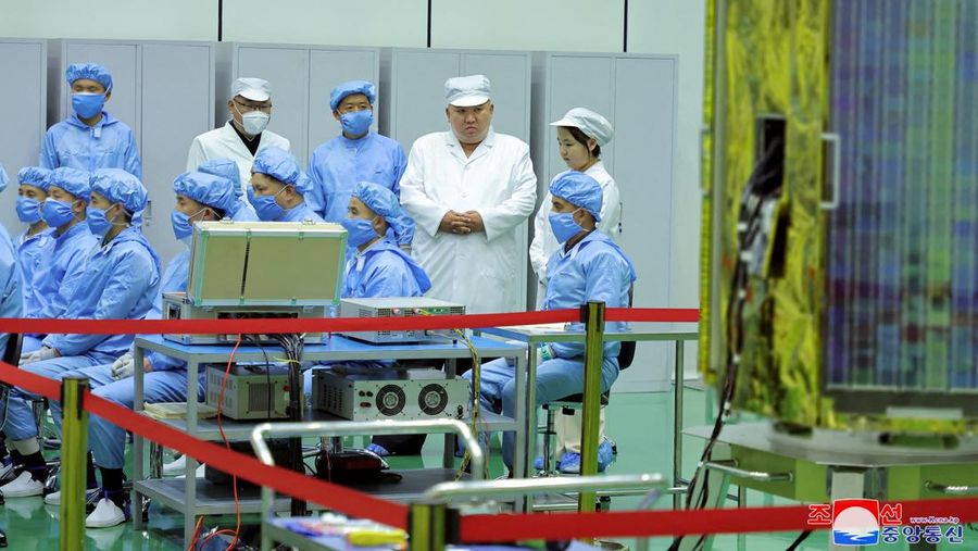 North Korean leader Kim Jong Un and his daughter Kim Ju Ae meet with members of the Non-permanent Satellite Launch Preparatory Committee, as he inspects the country's first military reconnaissance satellite, in Pyongyang, North Korea May 16, 2023, in this image released by North Korea's Korean Central News Agency on May 17, 2023. KCNA via REUTERS ATTENTION EDITORS - THIS IMAGE WAS PROVIDED BY A THIRD PARTY. REUTERS IS UNABLE TO INDEPENDENTLY VERIFY THIS IMAGE. NO THIRD PARTY SALES. SOUTH KOREA OUT. NO COMMERCIAL OR EDITORIAL SALES IN SOUTH KOREA. IMAGE HAS BEEN DIGITALLY OBSCURED AT SOURCE