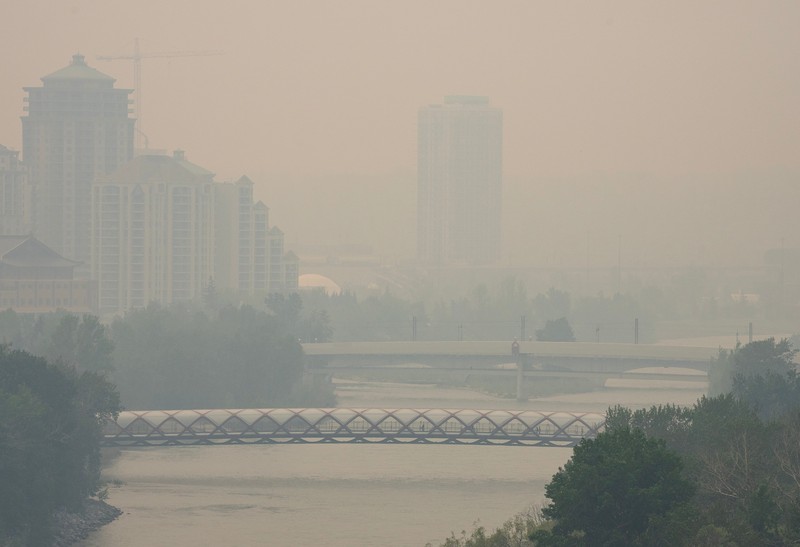 Buildings shrouded in smoke from wildfires in Calgary, Alberta, Canada, on Wednesday, May 17, 2023. Scenes in Calgary were reminiscent of Seattle last summer and San Francisco in 2020 as wind currents blew smothering wildfire smoke into those population centers, compromising air quality. Photographer: Todd Korol/Bloomberg via Getty Images