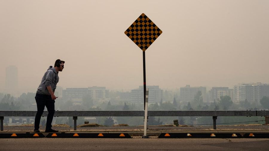 Buildings shrouded in smoke from wildfires in Calgary, Alberta, Canada, on Wednesday, May 17, 2023. Scenes in Calgary were reminiscent of Seattle last summer and San Francisco in 2020 as wind currents blew smothering wildfire smoke into those population centers, compromising air quality. Photographer: Todd Korol/Bloomberg via Getty Images