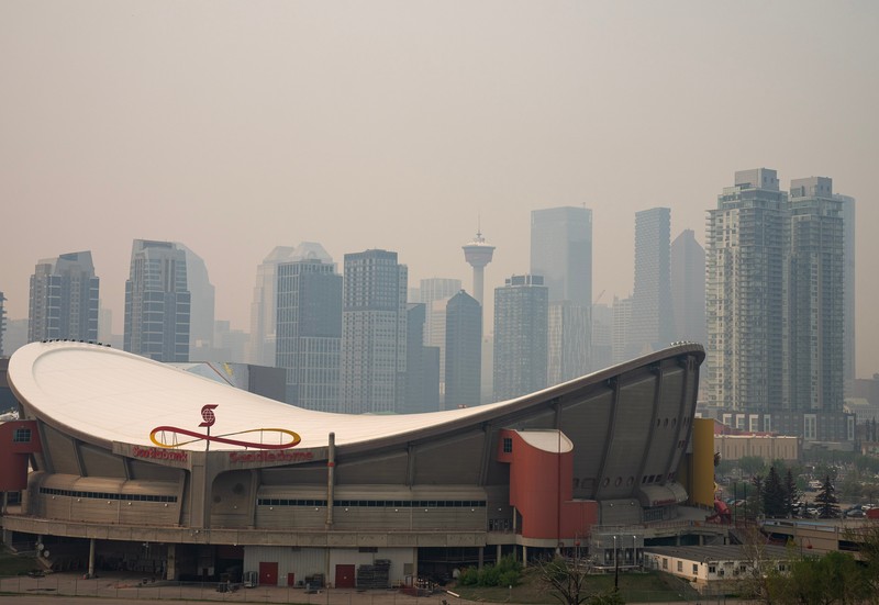 Buildings shrouded in smoke from wildfires in Calgary, Alberta, Canada, on Wednesday, May 17, 2023. Scenes in Calgary were reminiscent of Seattle last summer and San Francisco in 2020 as wind currents blew smothering wildfire smoke into those population centers, compromising air quality. Photographer: Todd Korol/Bloomberg via Getty Images