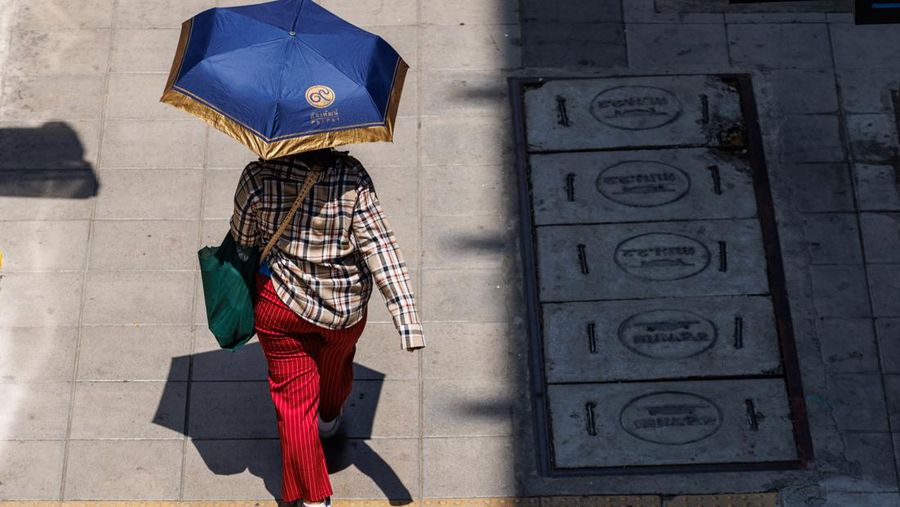 A woman shields herself from the sun in Bangkok, Thailand, on Thursday, May 18, 2023. The emerging El Nino is already contributing to severe heat that's roasted Southeast Asia in recent weeks. The weather pattern typically results in hotter, drier conditions in many parts of Asia. Photographer: Andre Malerba/Bloomberg via Getty Images